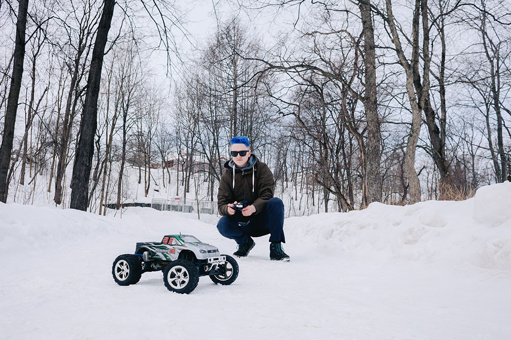 Aleksandr Muravev is playing with the radio-controlled car
