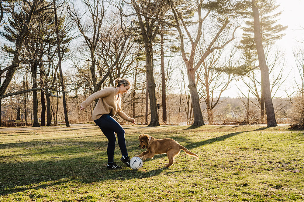 Katy Peters plays football with her dog Gimli