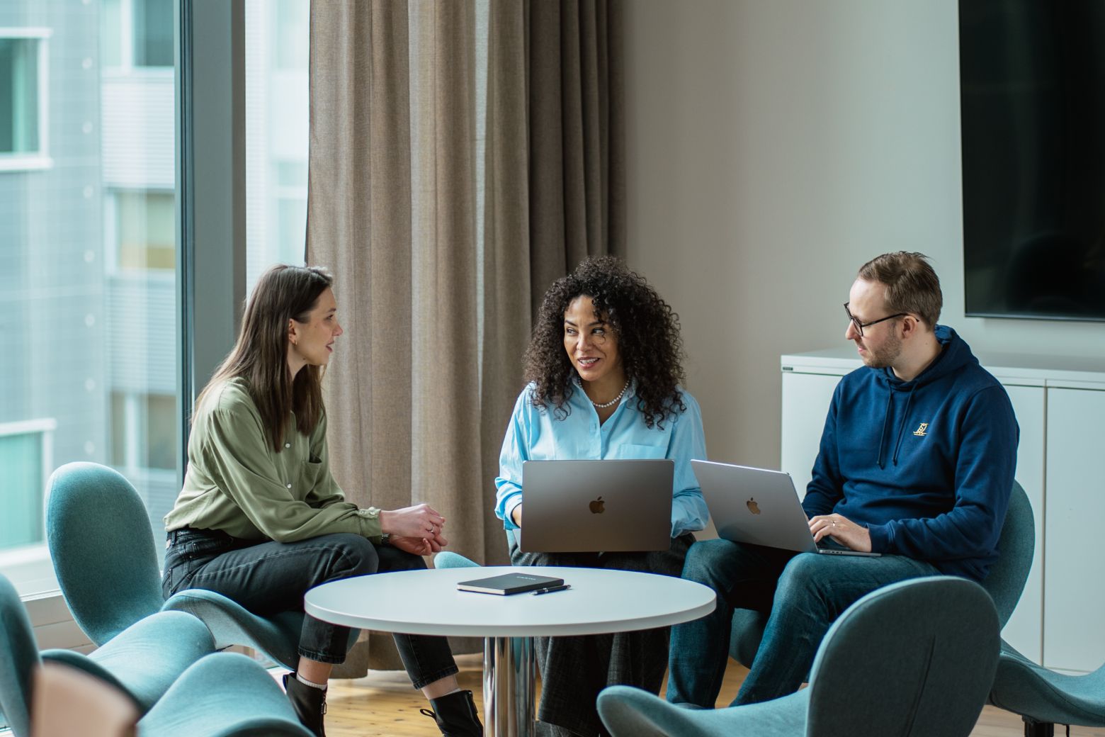 Team members discussing around a round table