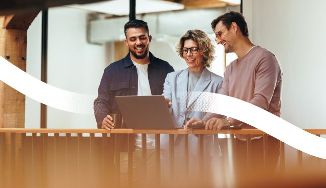 Three colleagues laughing in the office