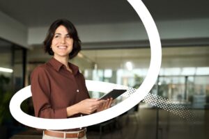 A Valamis branded image of a women holding a tablet. Part of the Fosway AI research assessment 2026 for Valamis